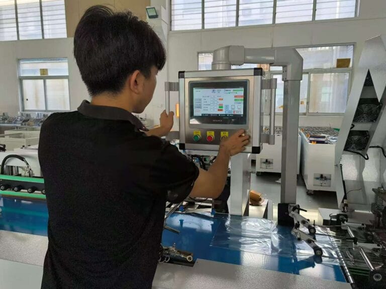 Technician Operating Cartoning Machine HMI for IoT Remote Maintenance in Factory Workshop