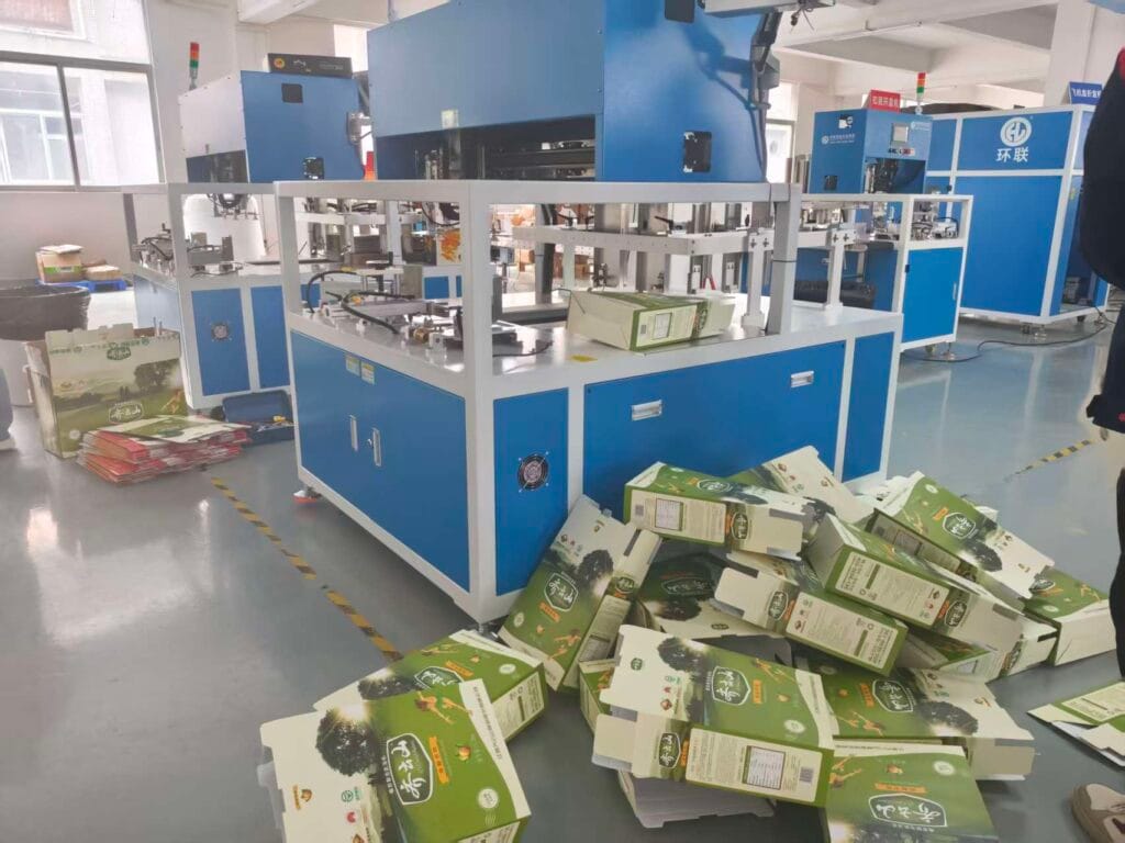 High Speed Snap Lock Bottom Box Folding Machine in operation, efficiently producing cartons with snap-lock bottoms at high speed.