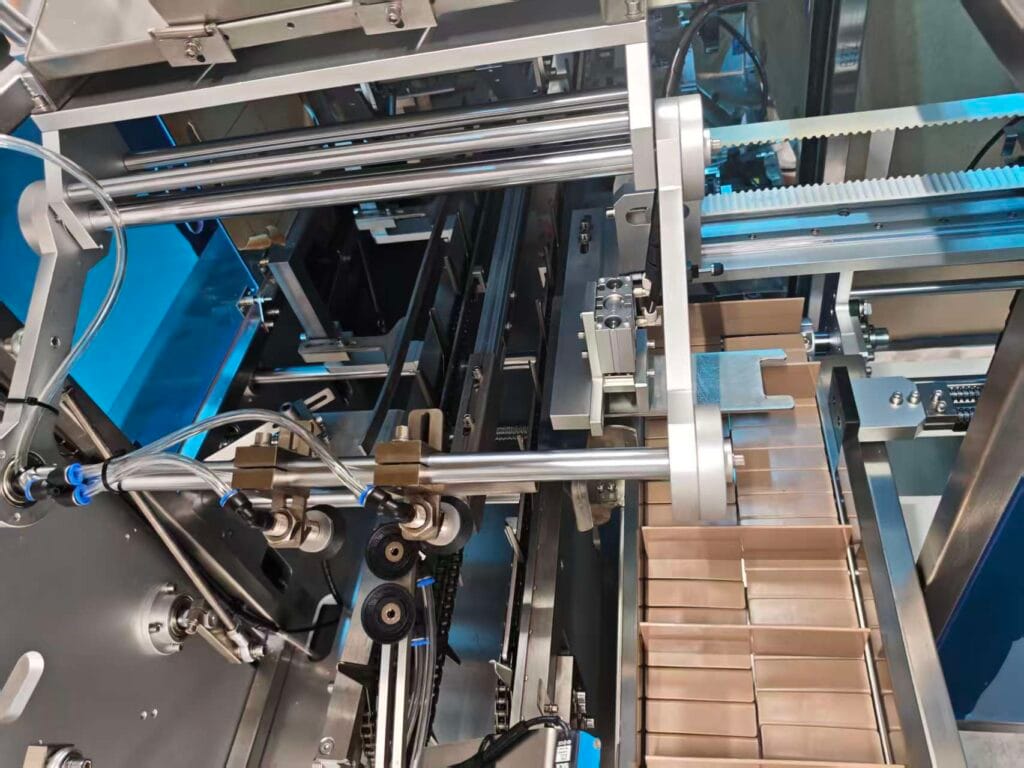 Internal details of automatic cartoning machine showing modular machine structure